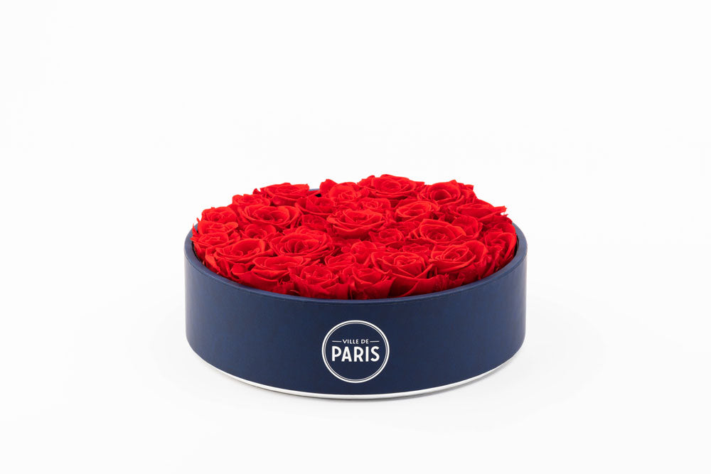 Ville de Paris Round Black Box, expertly constructed with a leather finish. Inside, you'll find a magnificent arrangement of Eternity Roses nestled in Parisian hat box-inspired vases. These traditional arrangements do more than just decorate a room; they transform it, bringing grace and majesty into every corner.