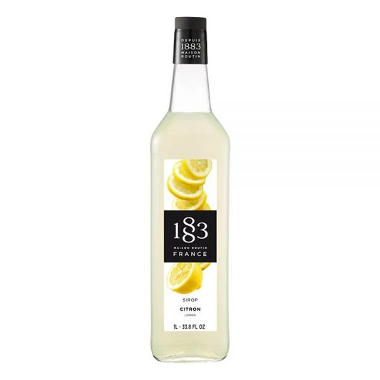 A bottle of 1883 Routin Lemon Flavor Syrup featuring a naturally light-yellow hue and a bright citrus taste. Perfect for sodas, teas, smoothies, and desserts. Made in France with pure cane sugar and no added coloring.