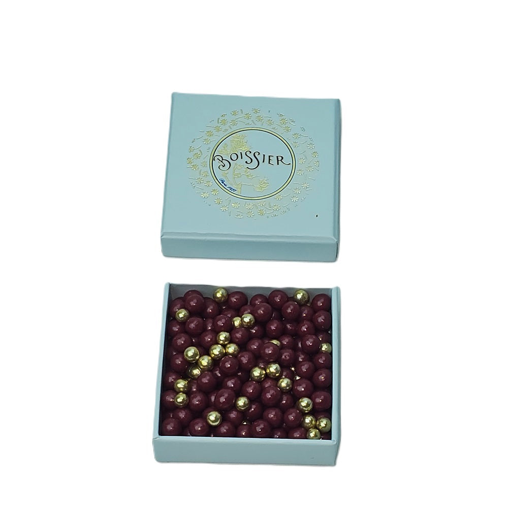 Elevate your indulgence with Maison Boissier's, a symbol of luxury presented in a stunning blue box with "Boissier" elegantly scripted in gold. This exquisite creation features raspberry and gold chocolate pearls, a testament to Maison Boissier's tradition of excellence.