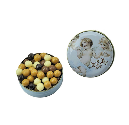 Dive into the world of Maison Boissier's Crispy Chocolate Pearls, a heavenly creation nestled within a pillbox container adorned with delicate angels. 