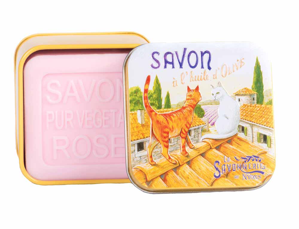 Experience the charm of Provence with La Savonnerie de Nyons' rose-scented soap, presented in a unique 'Cats on the Roof' vintage metal tin, illustrated by artist Luc Mazan.